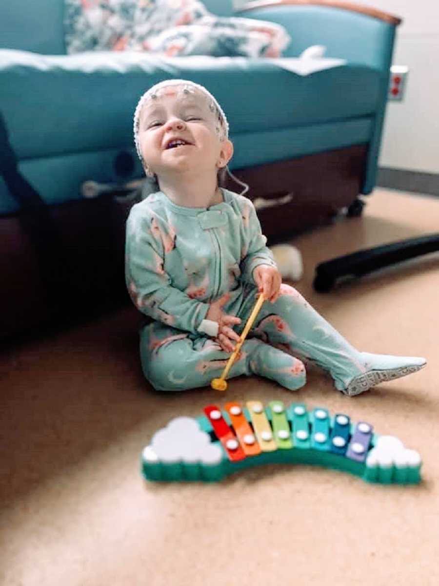 A little girl with Dravet Syndrome plays with a xylophone