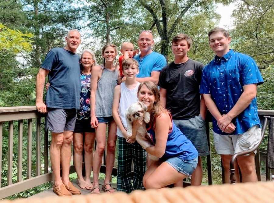 A family stand out on a porch