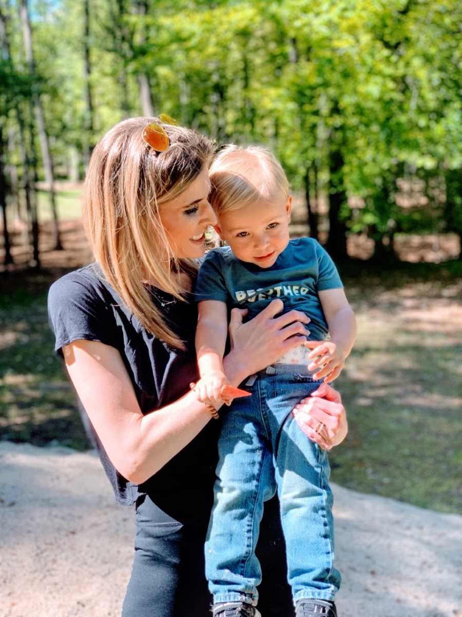 A mom holds her son up