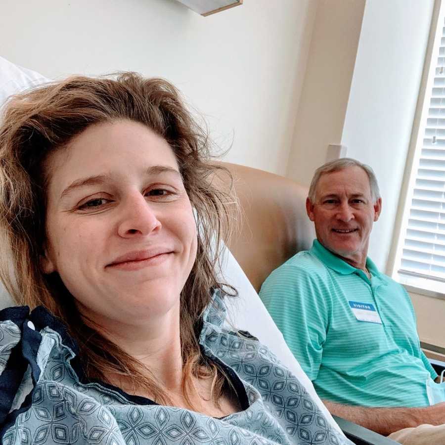 A woman and her father sit together in a hospital