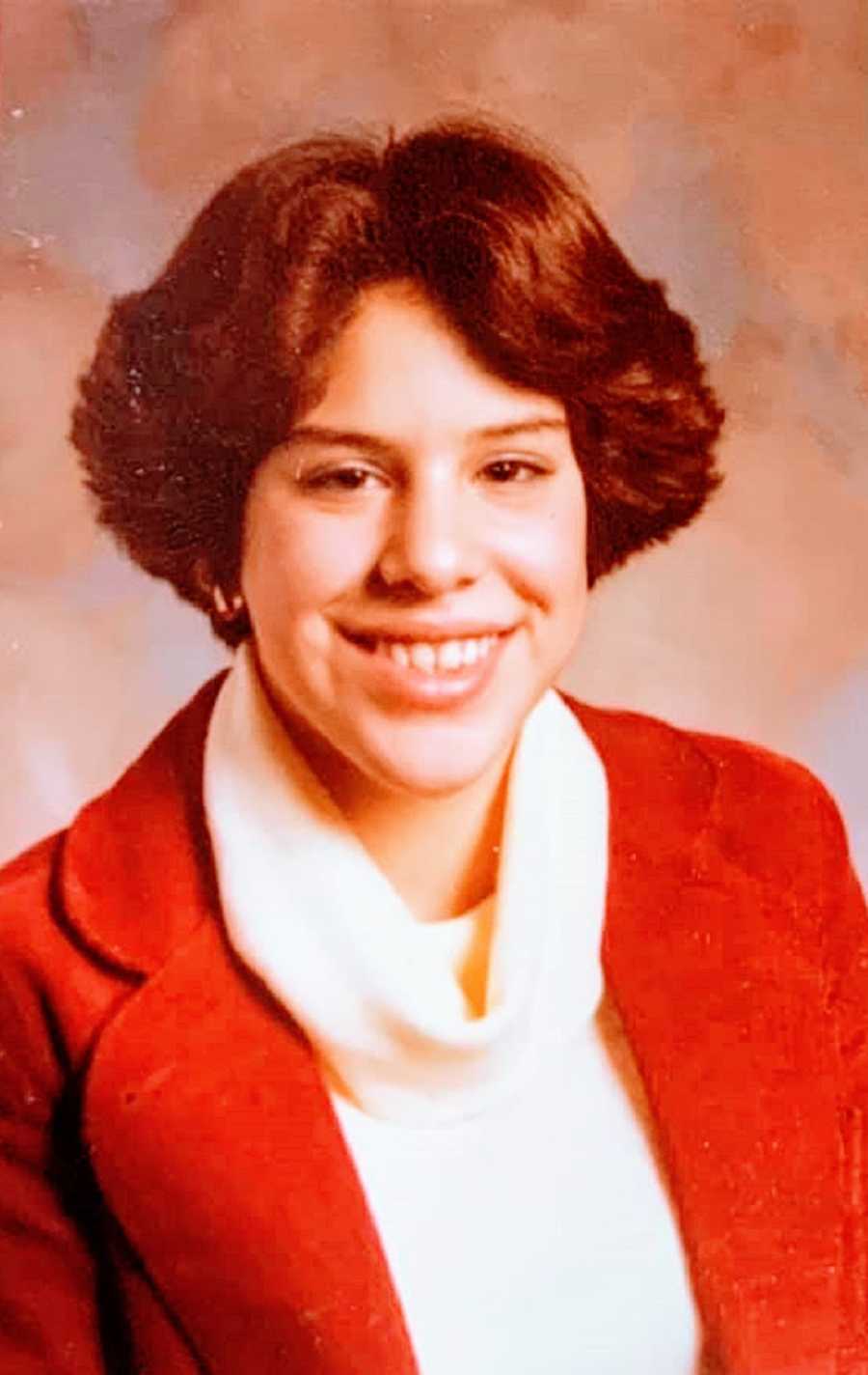 A young woman wearing a red jacket and a turtleneck