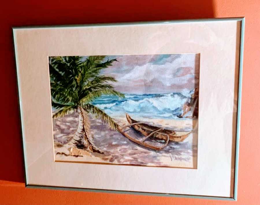 A painting of a boat washed on shore