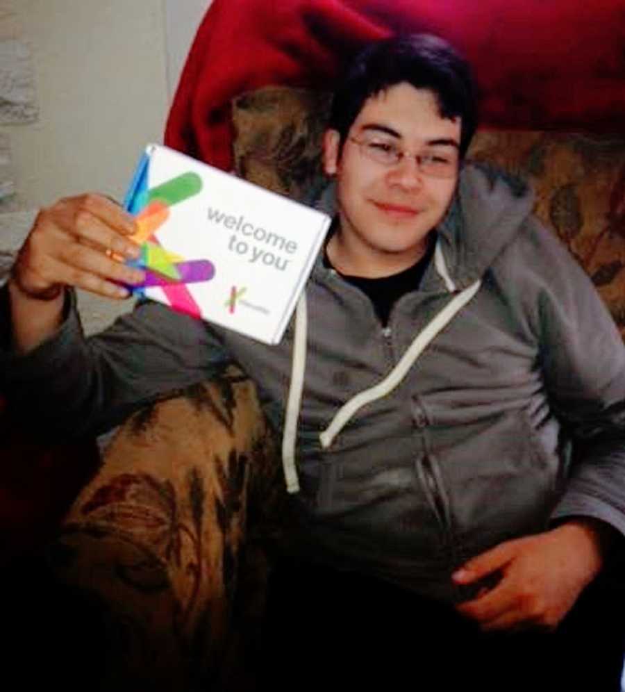 A boy holds up a DNA test kit