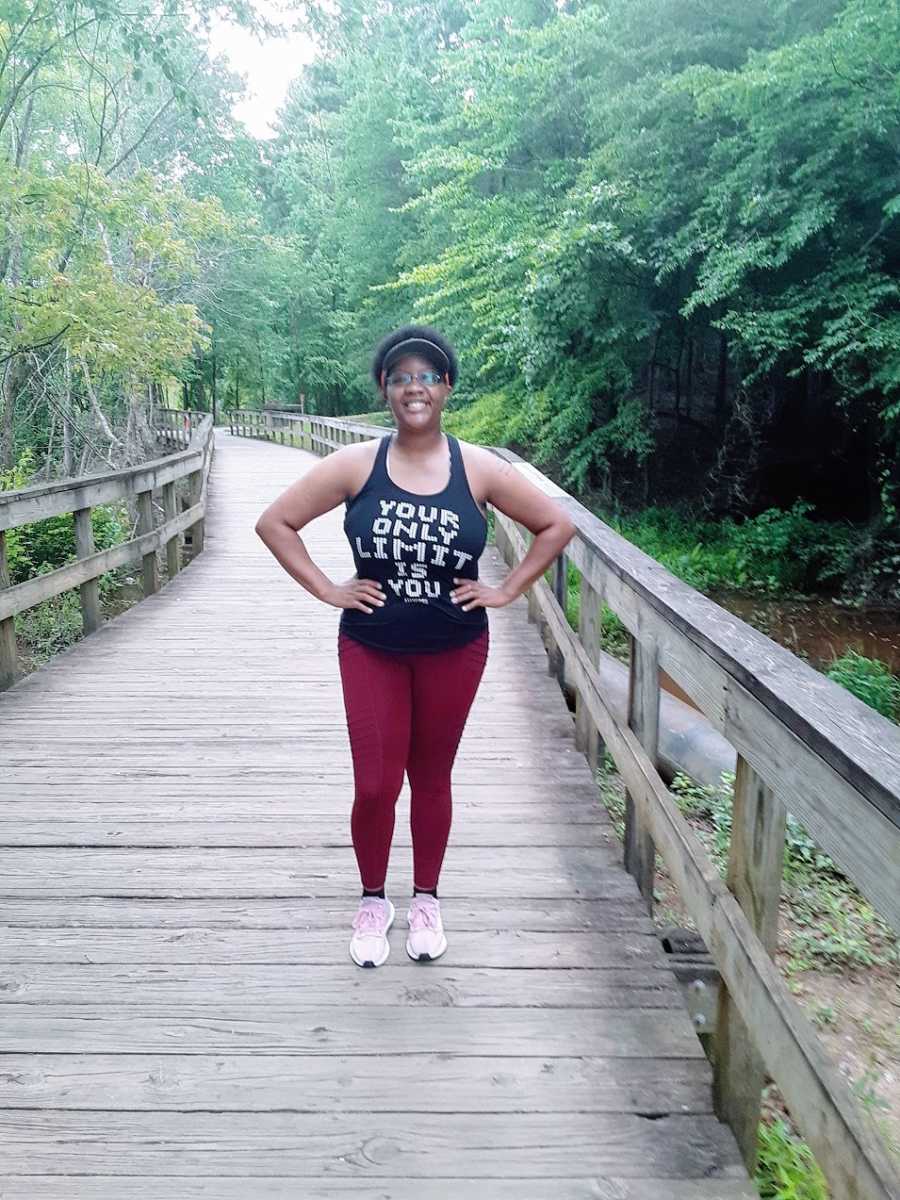 A woman stands on a bridge in recovery