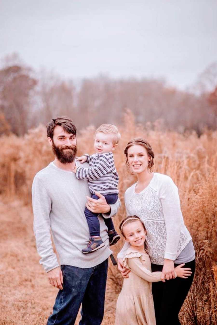 Parents and their two children out in a field