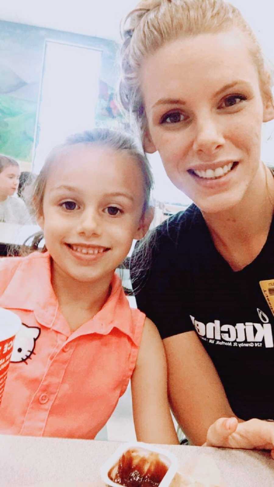 A little girl in a Hello Kitty shirt and her mom