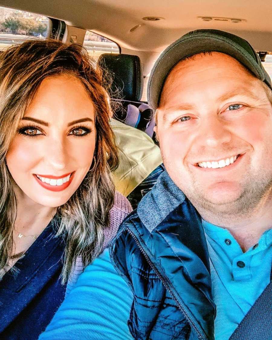 A mom and her husband sit together in their car