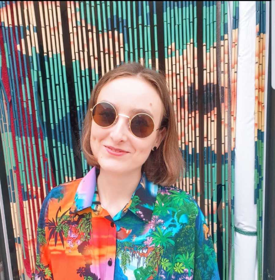 A woman wearing a colorful shirt and sunglasses