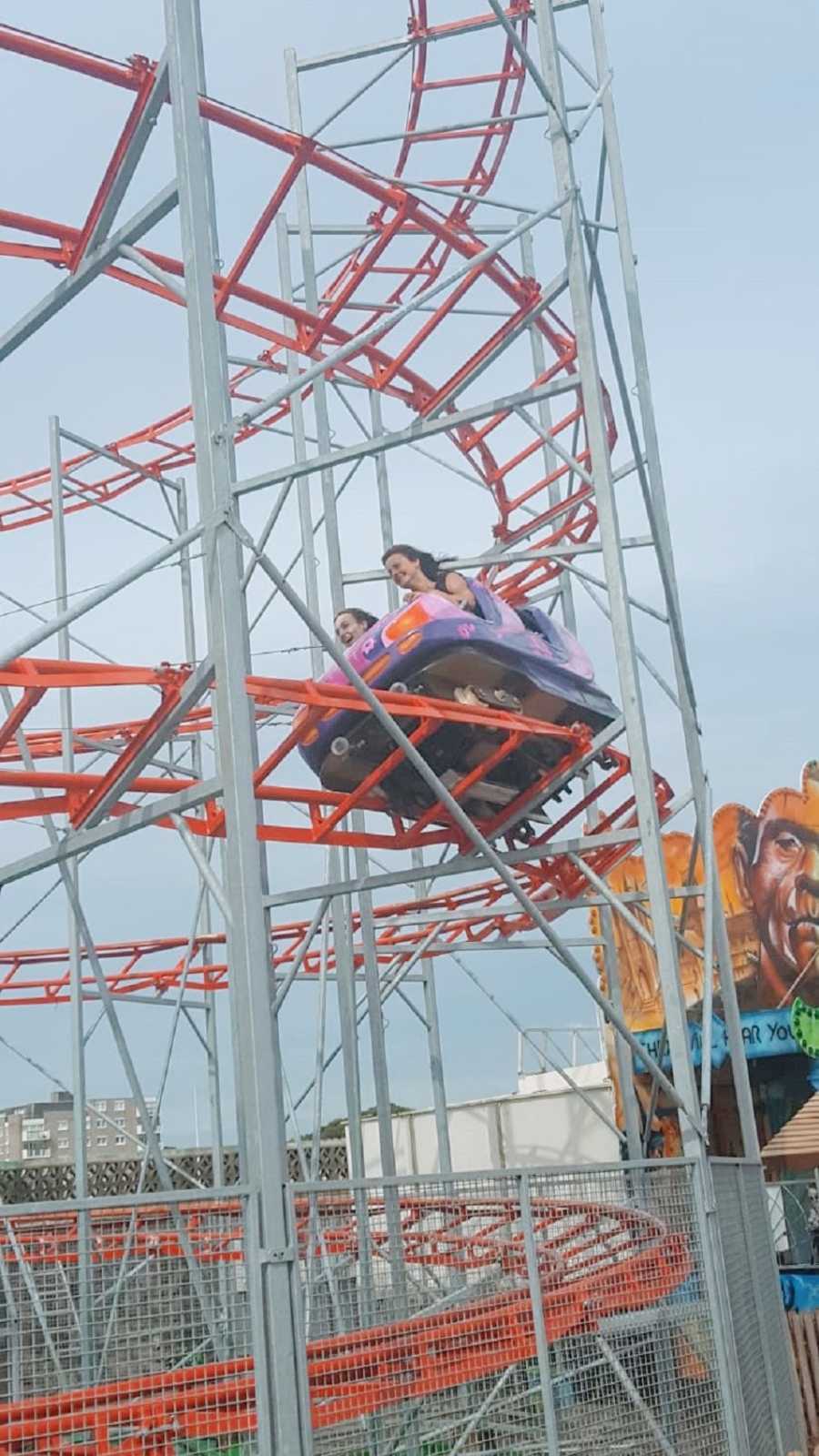 A woman and her mother ride a rollercoaster together