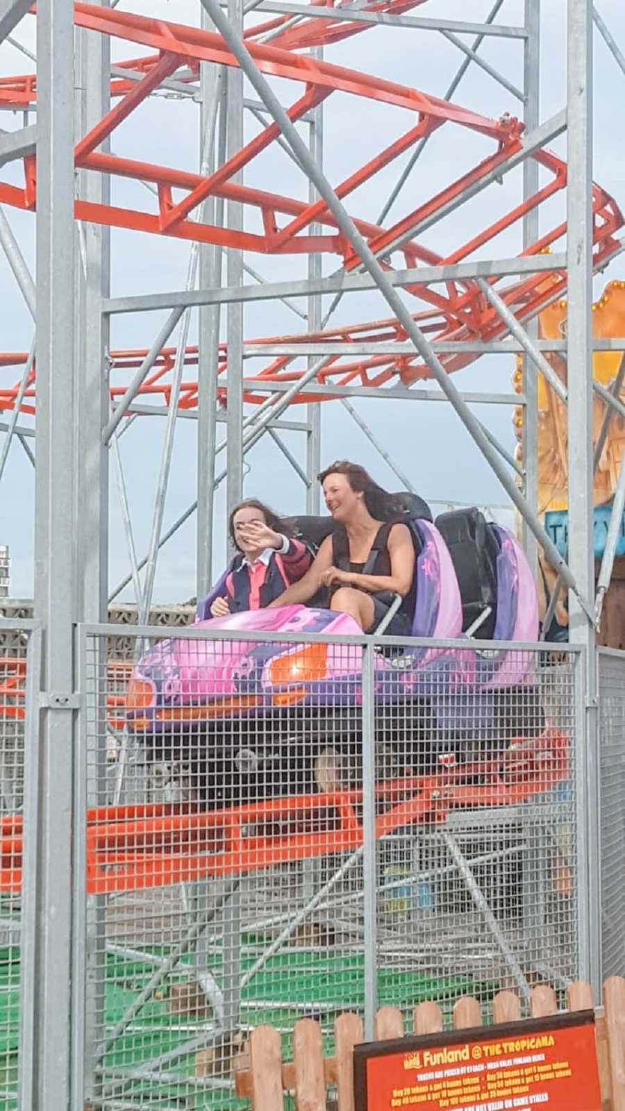 A woman and her mother riding a roller coaster