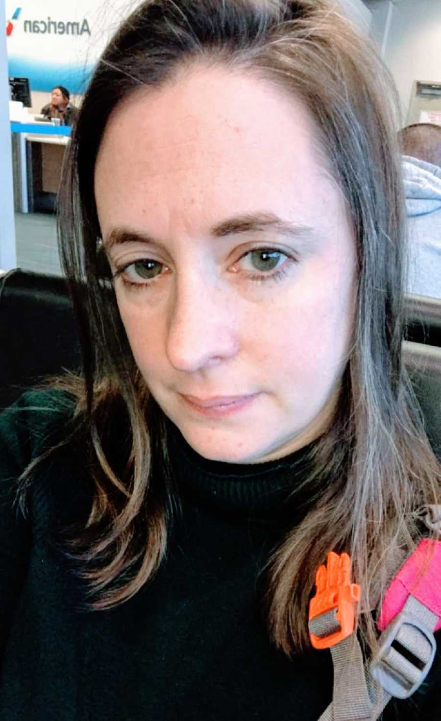 A woman sits at an airport