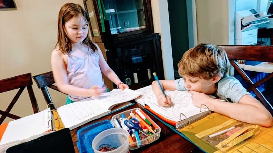 A pair of children work on homework at a table