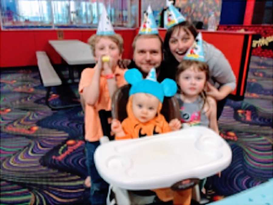 A family sit together to celebrate a birthday