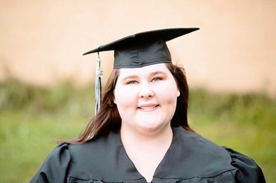 A woman wearing a cap and gown for graduation