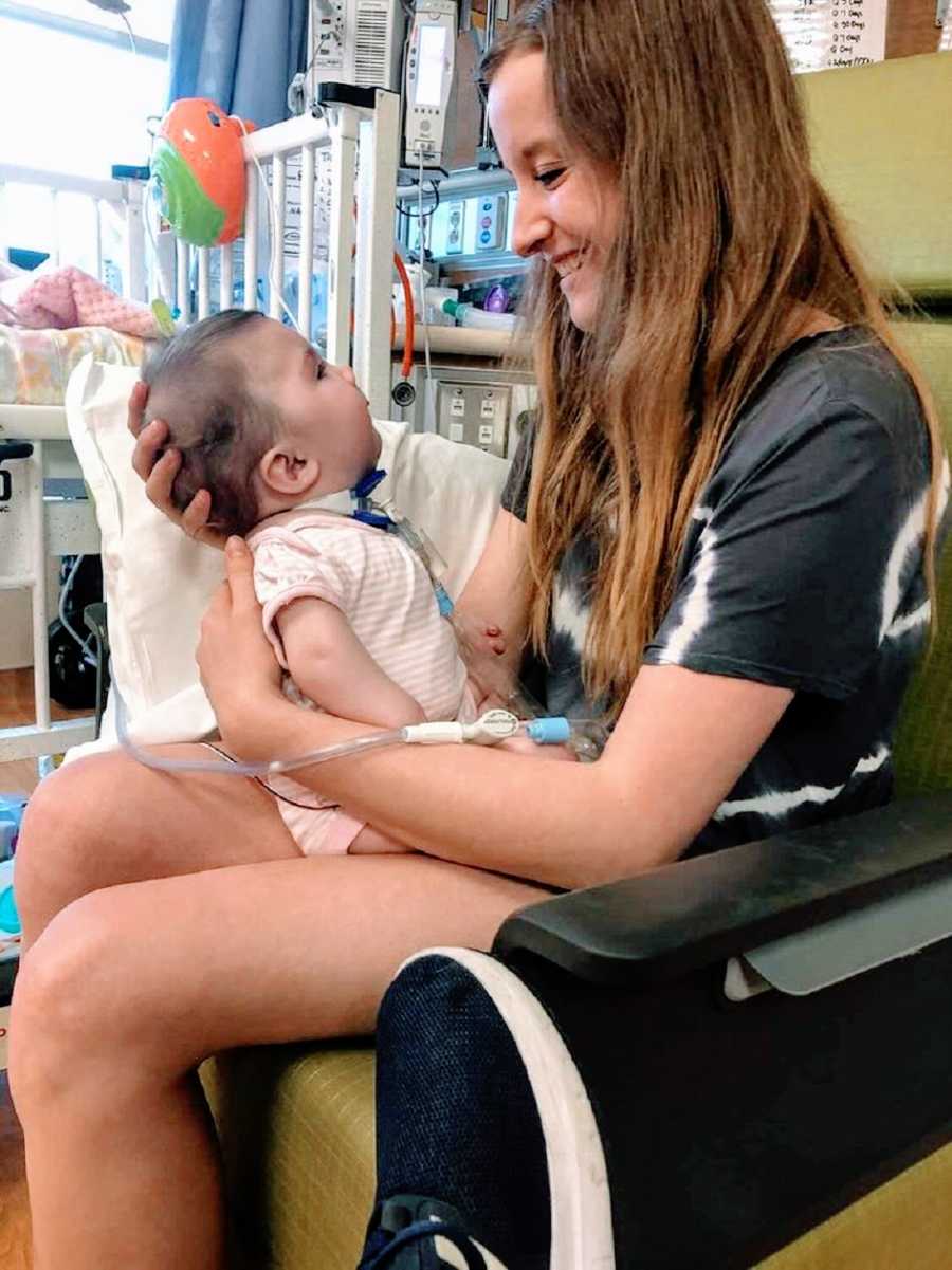 A mother holds her adopted baby girl