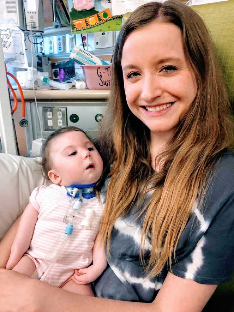 A woman sits in the hospital with a baby girl