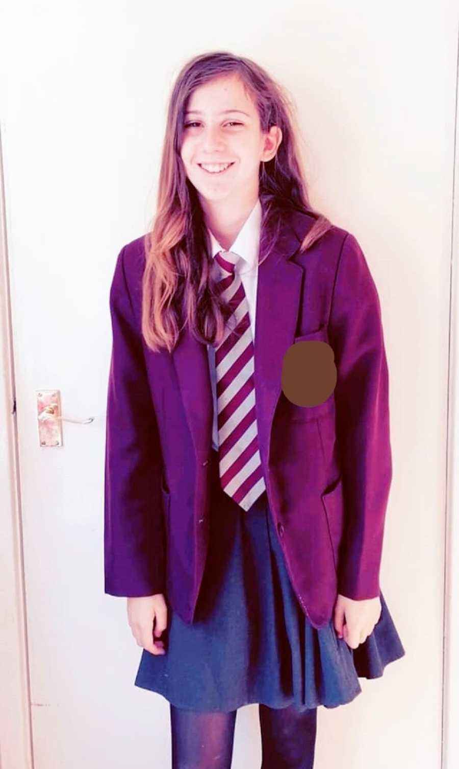 A child stands in a school uniform