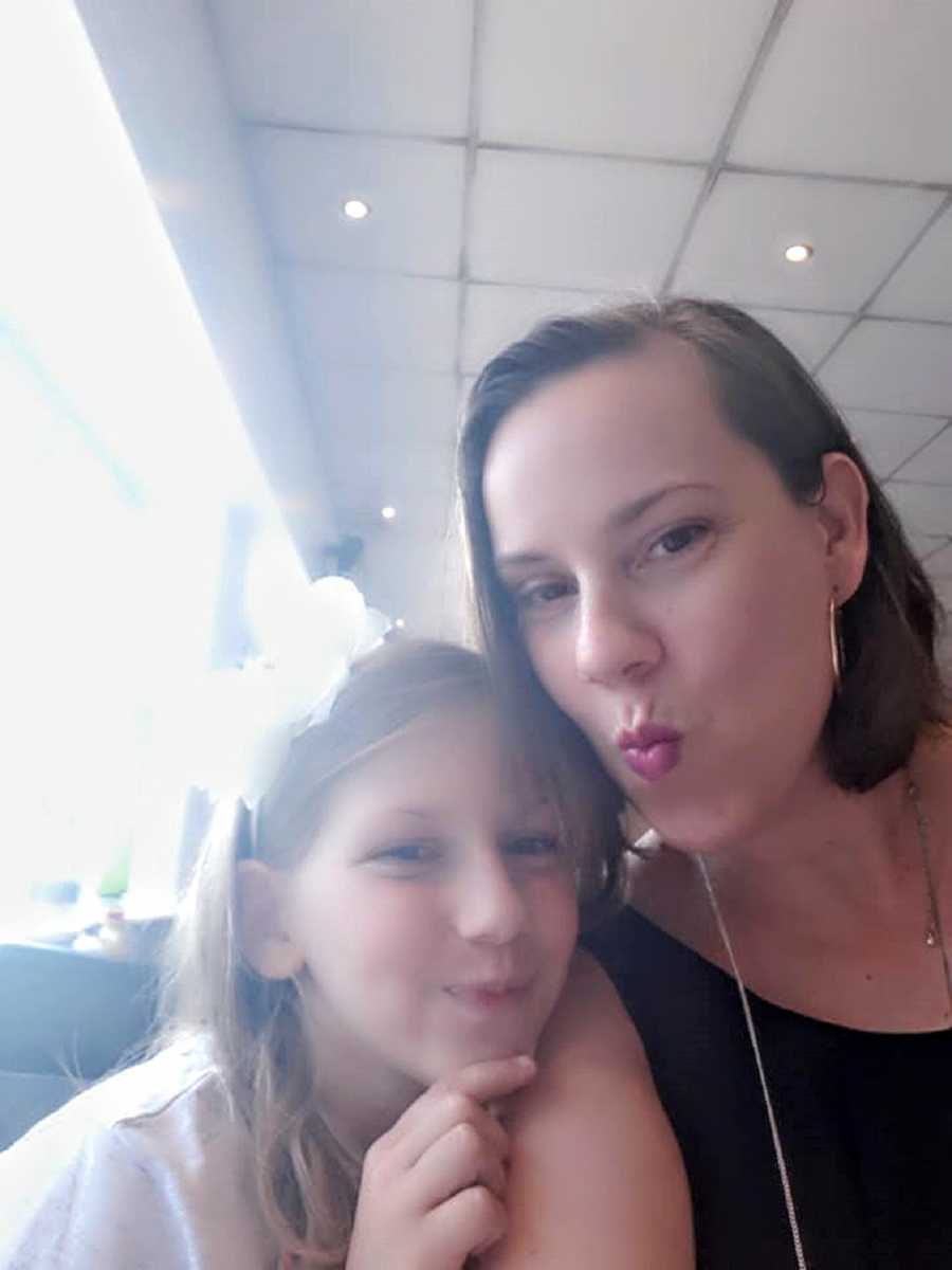 A mother and her daughter with autism make faces at the camera