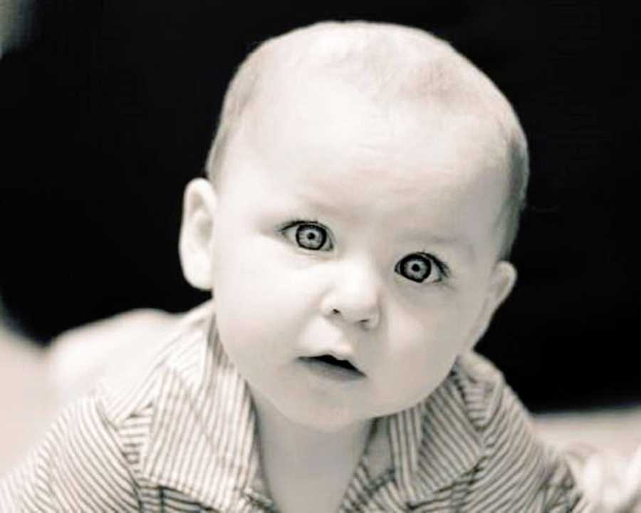 An 8-month-old baby boy in black and white