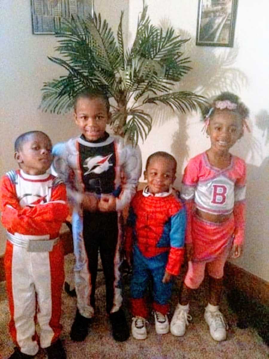 Four siblings wear superhero costumes for Halloween