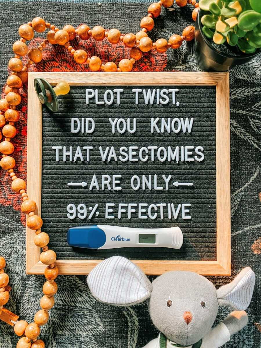 Couple unexpectedly pregnant after a vasectomy fail take a photo for their pregnancy announcement with a sign that reads "Plot twist, did you know that vasectomies are only 99% effective"