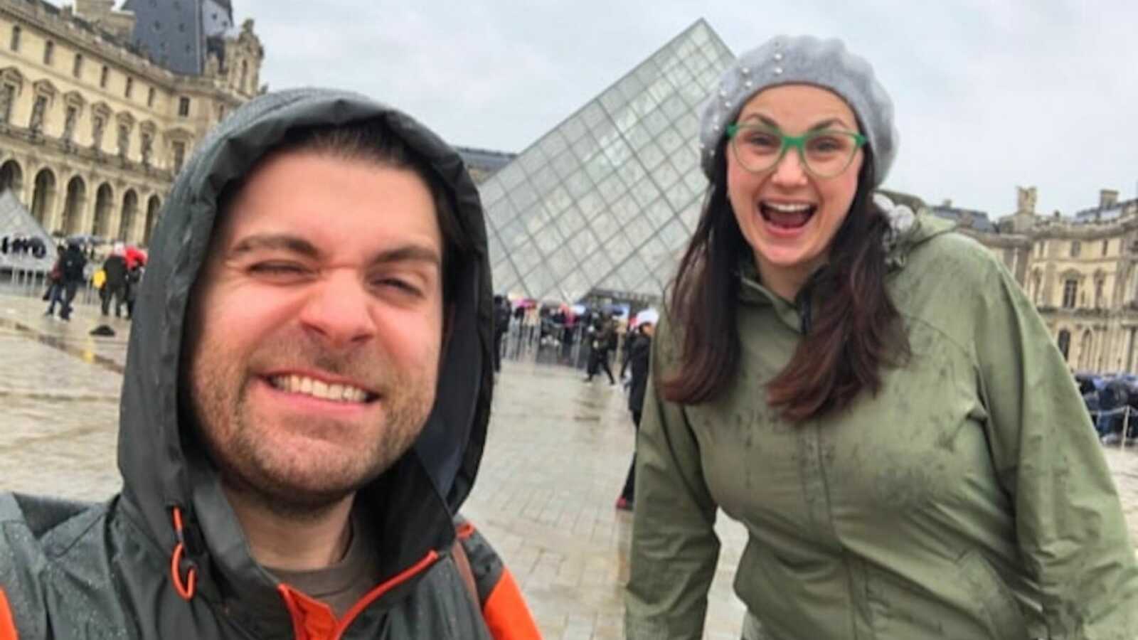 Couple taking selfie in rain coats in France