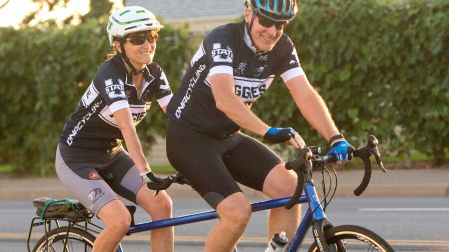 Wife and husband in matching shirts bike riding together