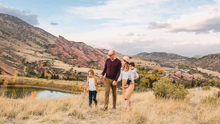 family of four walking through mountains