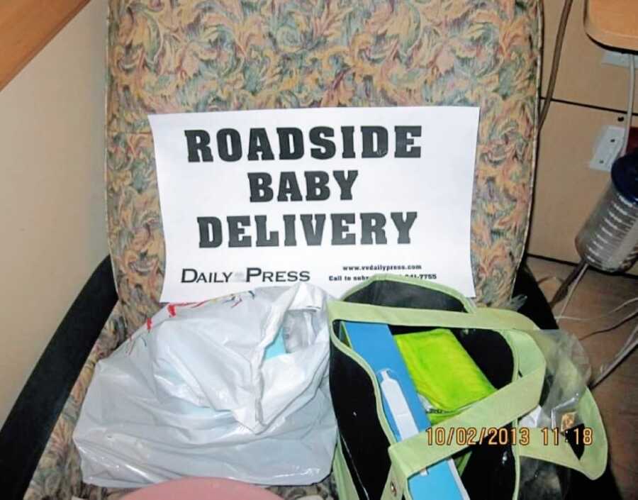 Woman takes photo of sign that reads "roadside baby delivery" after giving birth in her car