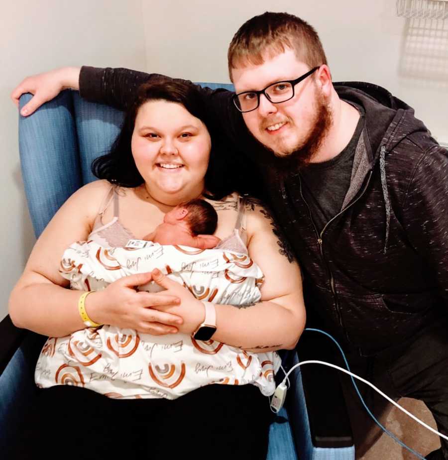 Young married couple hold their firstborn baby after suffering through three miscarriages