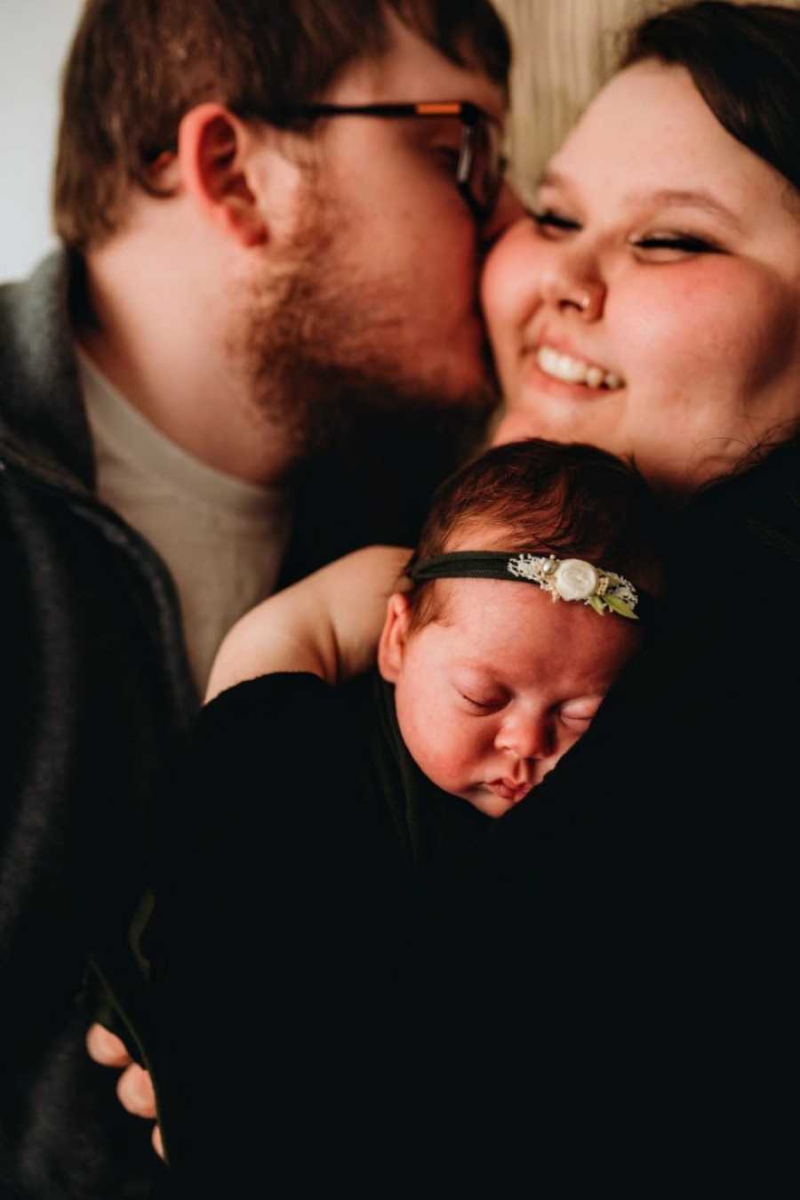 Young married couple look euphoric as they hold their miracle rainbow daughter after bringing her home from 2 months in the NICU