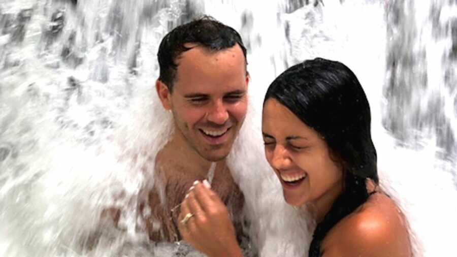 Couple laughing in waterfall