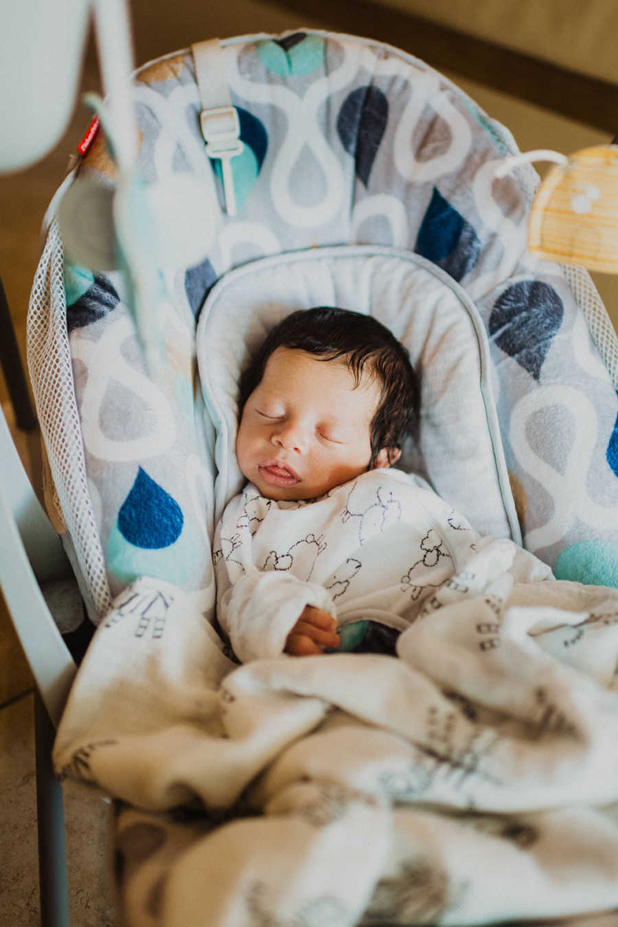 Mom snaps a photo of her son born with a limb difference sleeping in a baby carrier