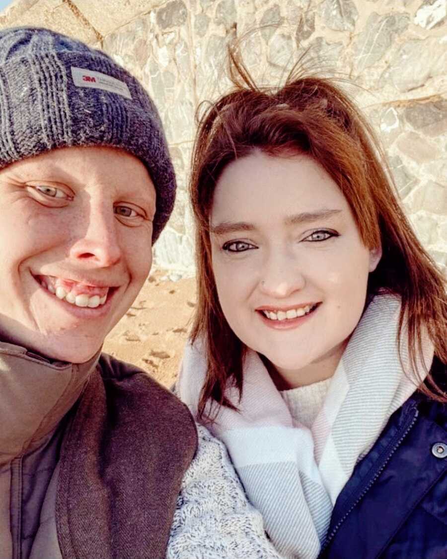 Young woman with severe asthma and Crohn's disease takes a selfie with her husband during a vacation