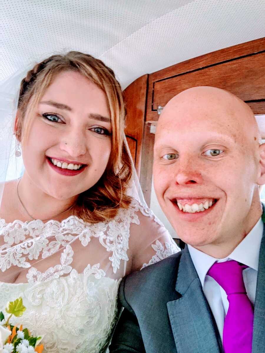 Newlyweds take a selfie together after their wedding reception