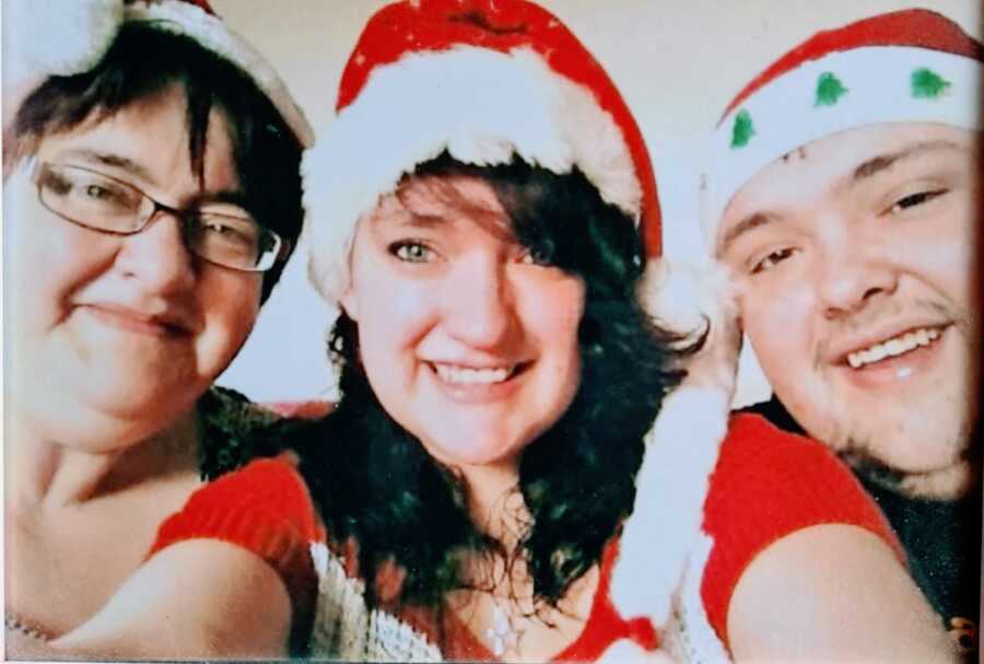 Teen girl takes a selfie with her mom and brother, who both have asthma, while wearing Santa hats