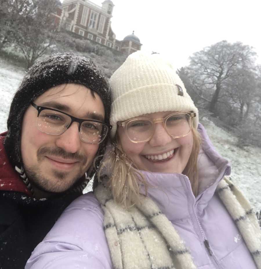 couple smiling together in the snow