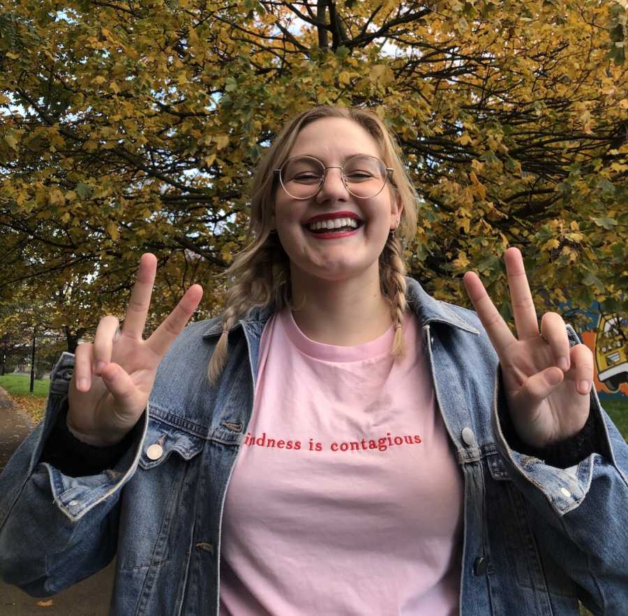 woman smiling with peace signs