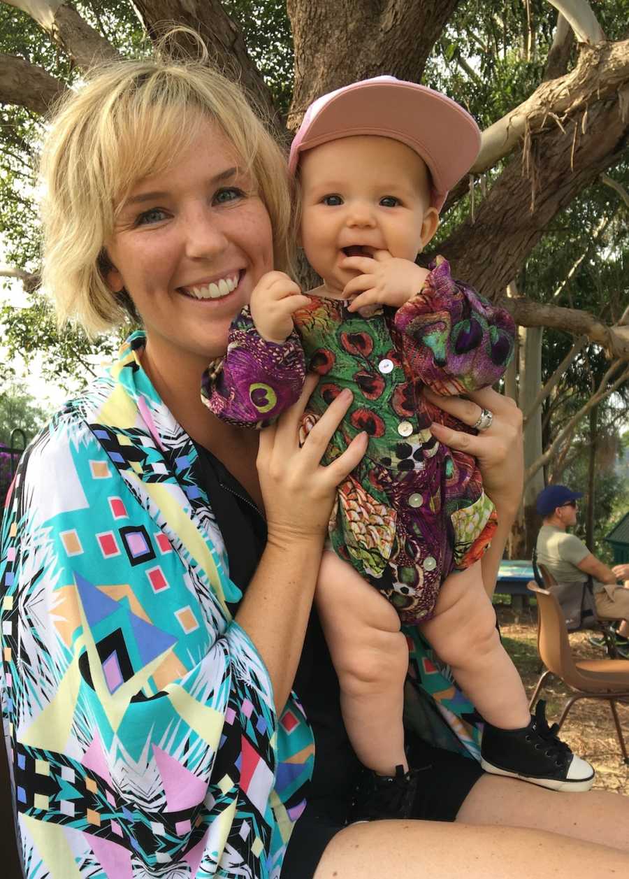 mom holding daughter