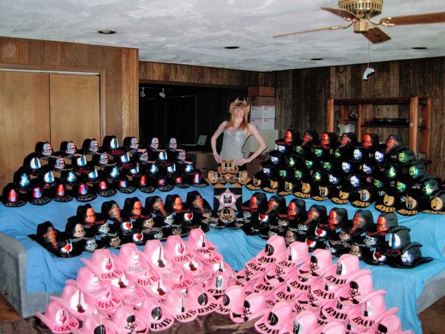 Woman who made hats for Bret Michaels smiles in front of dozens of hats she made