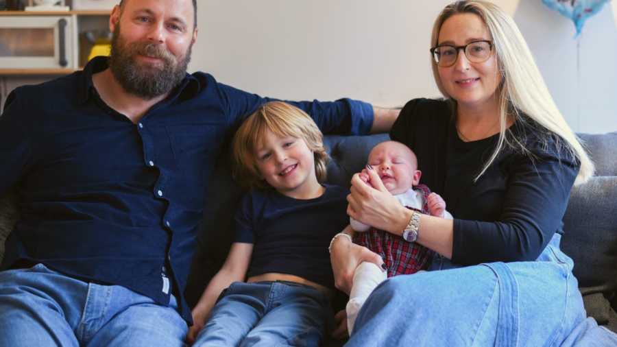 mom, dad and two children on couch