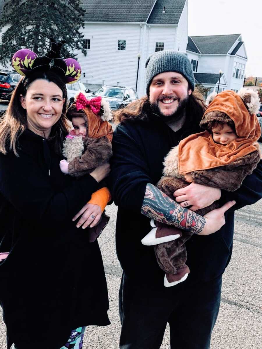 Family of four take a photo together on Halloween while dressed up in costumes