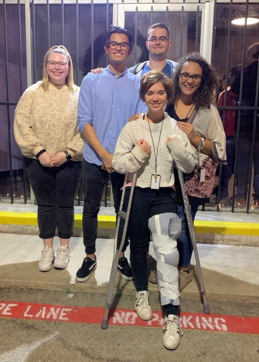 woman on crutches with leg brace with friends