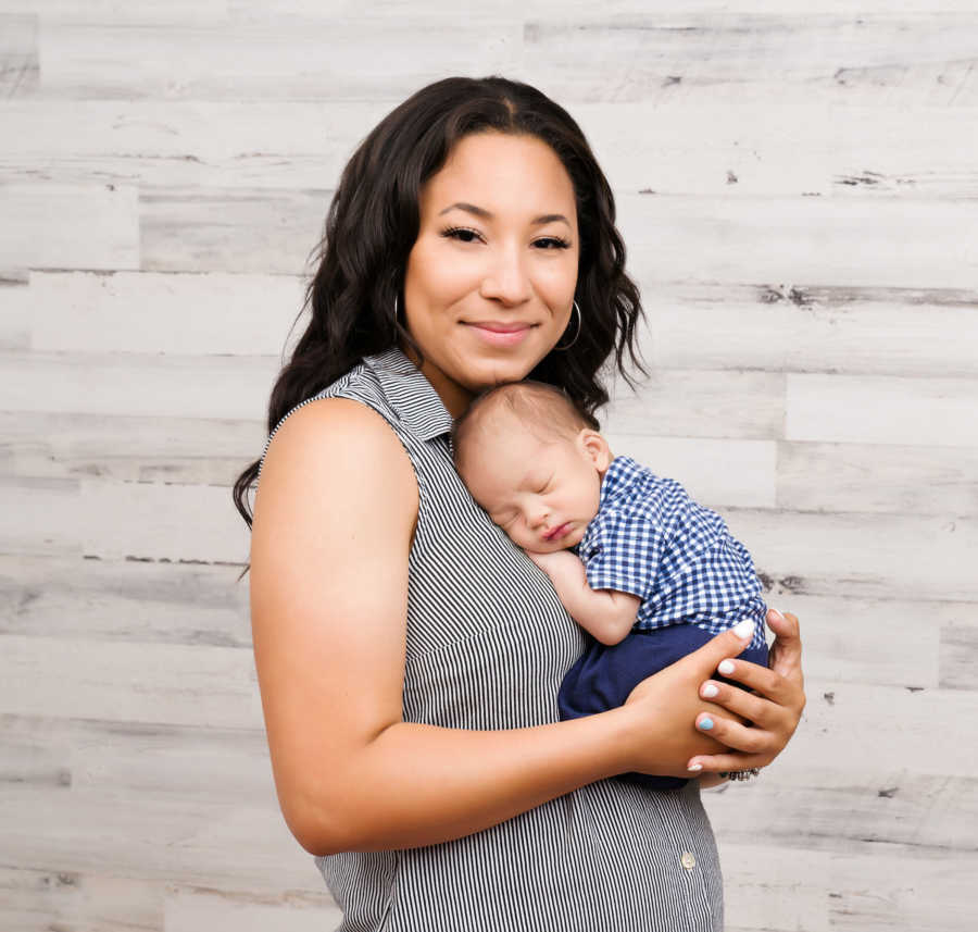 woman holding her baby, smiling