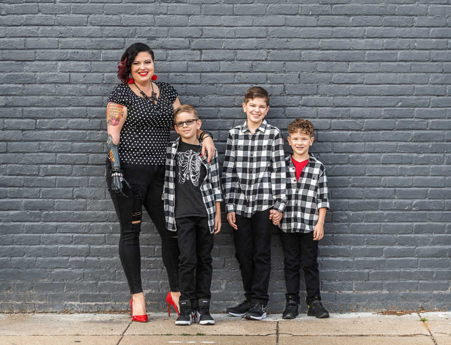 woman with prosthetic arm and her three kids