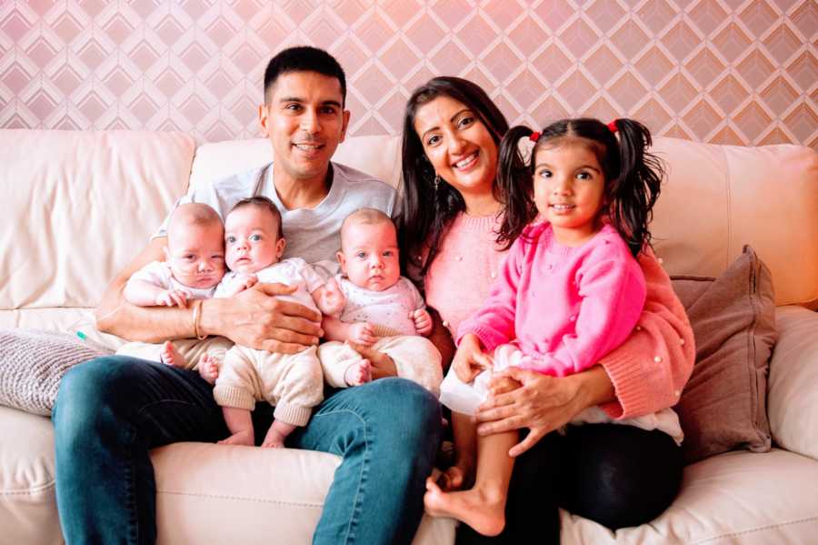 Family of six take pink-themed family photo with their children conceived through surrogacy