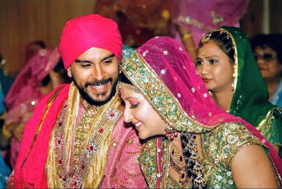 Young Indian couple share an intimate moment during their traditional wedding