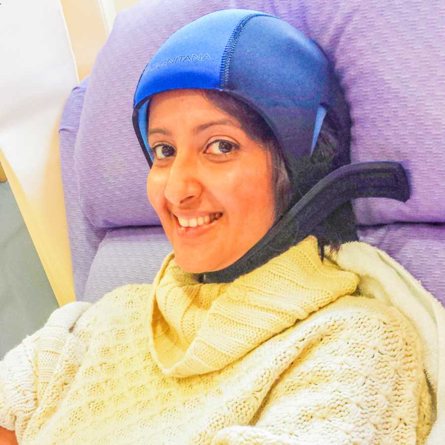Woman battling aggressive stage 3 breast cancer smiles for the camera as she prepares for chemotherapy