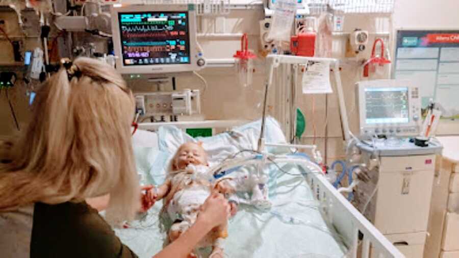 Little girl born with no immune system lays in the hospital bed before surgery