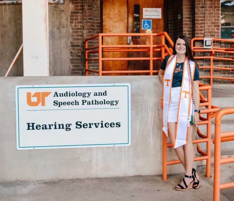 girl at audiology clinic in graduation cords